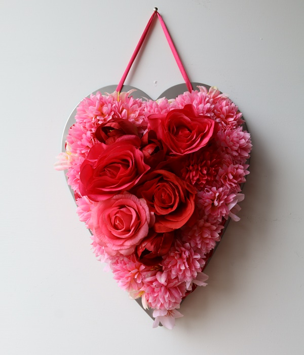 Beautiful flowers with metal heart as frame