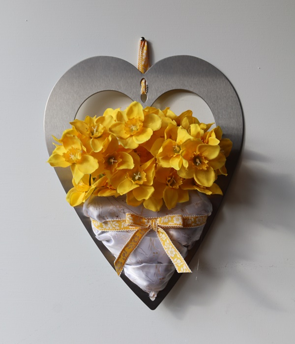 Spring daffodils in metal heart frame